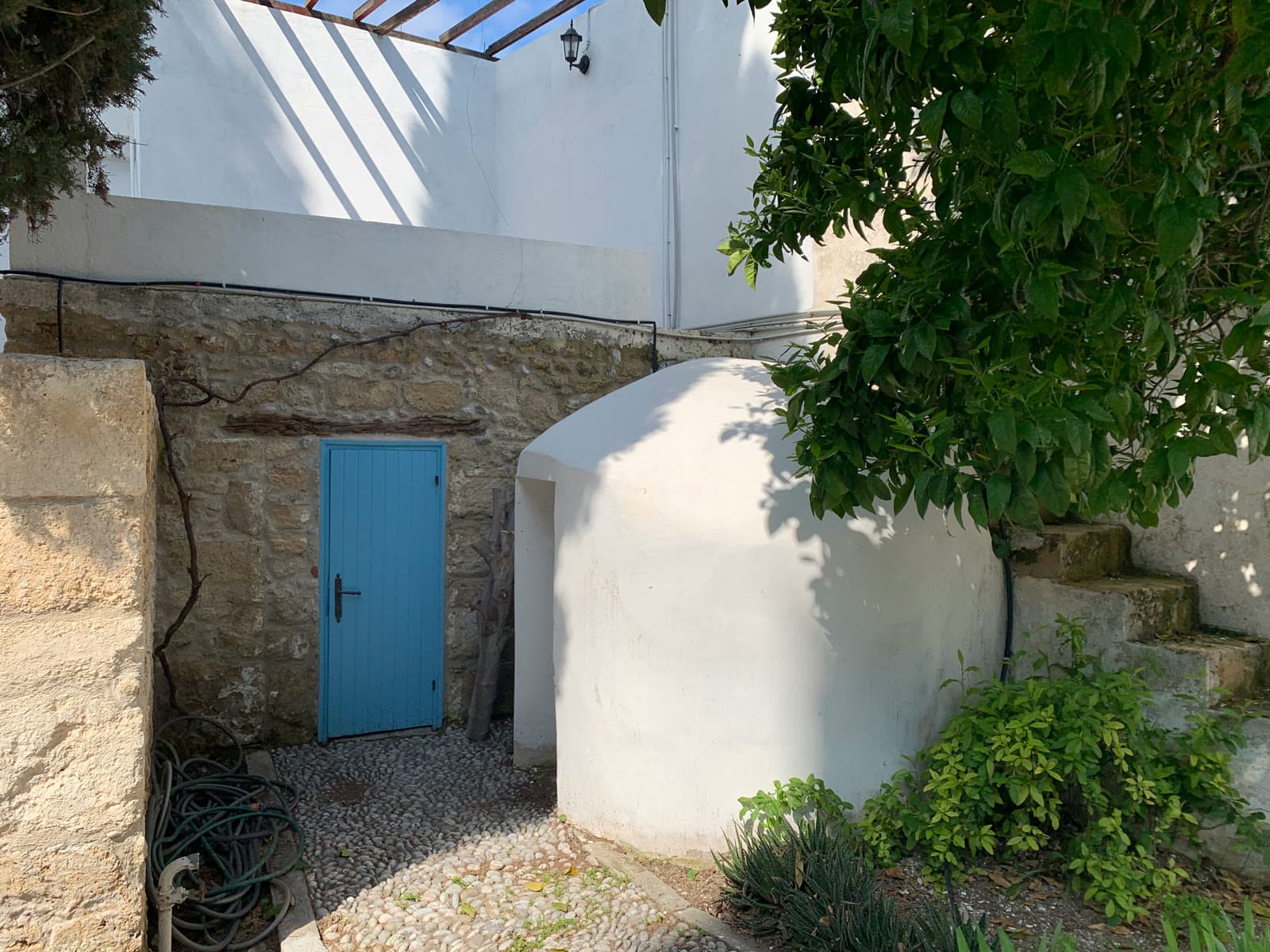 A cobalt-blue door set into the old stone wall.