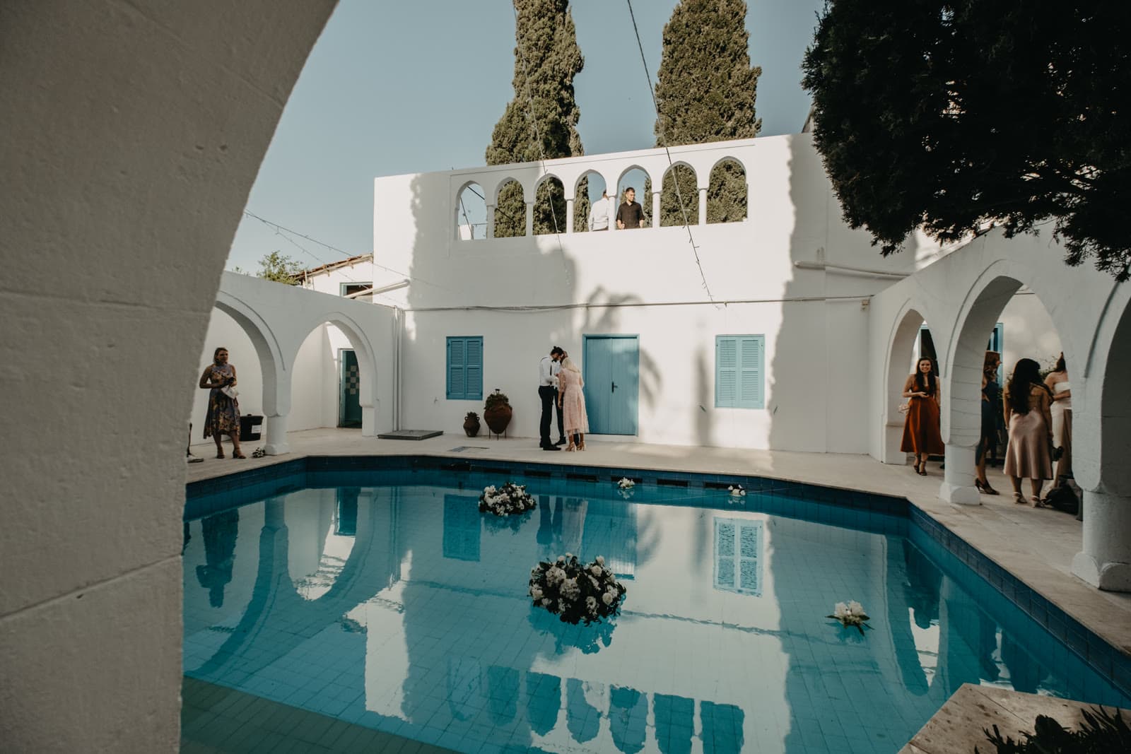 The pool in the courtyard of The Old Monastery, with stone arches behind.