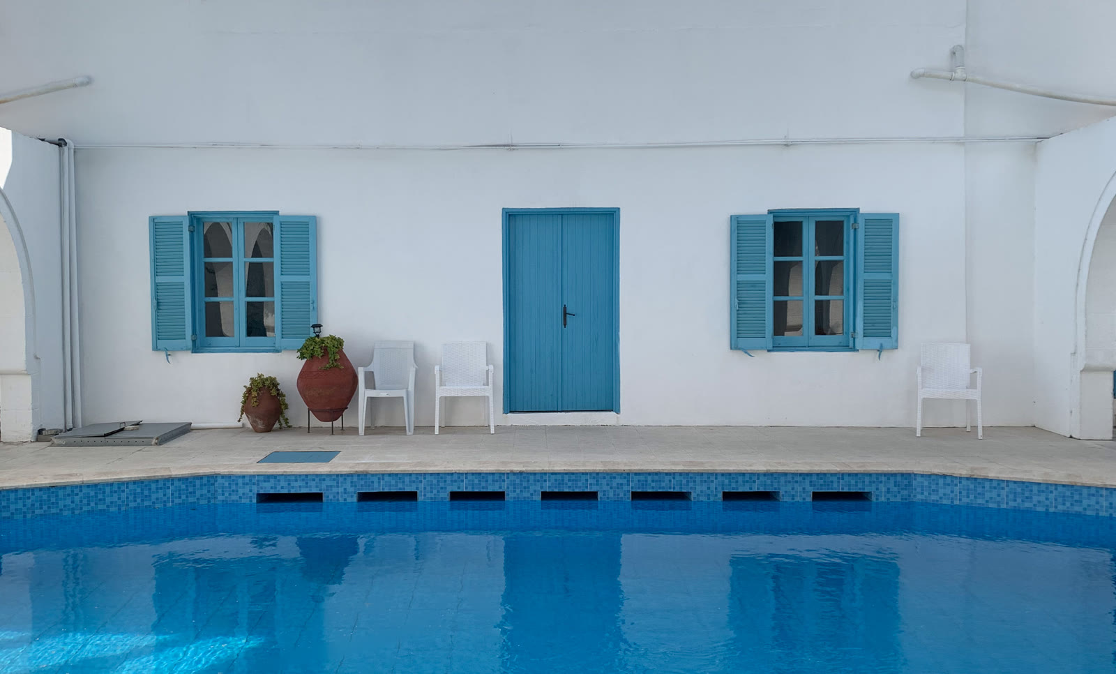 Cobalt shutters by the pool